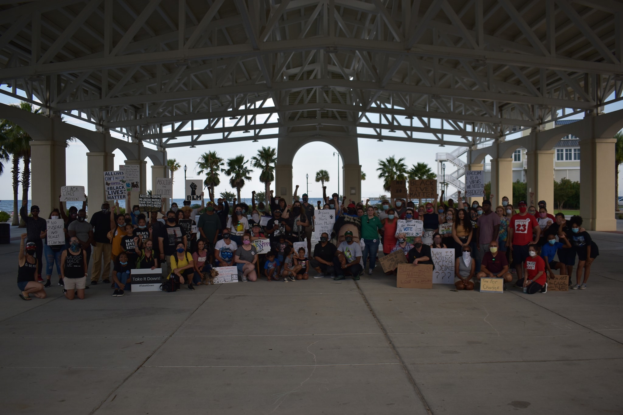 A large group of protestors sit for a picture